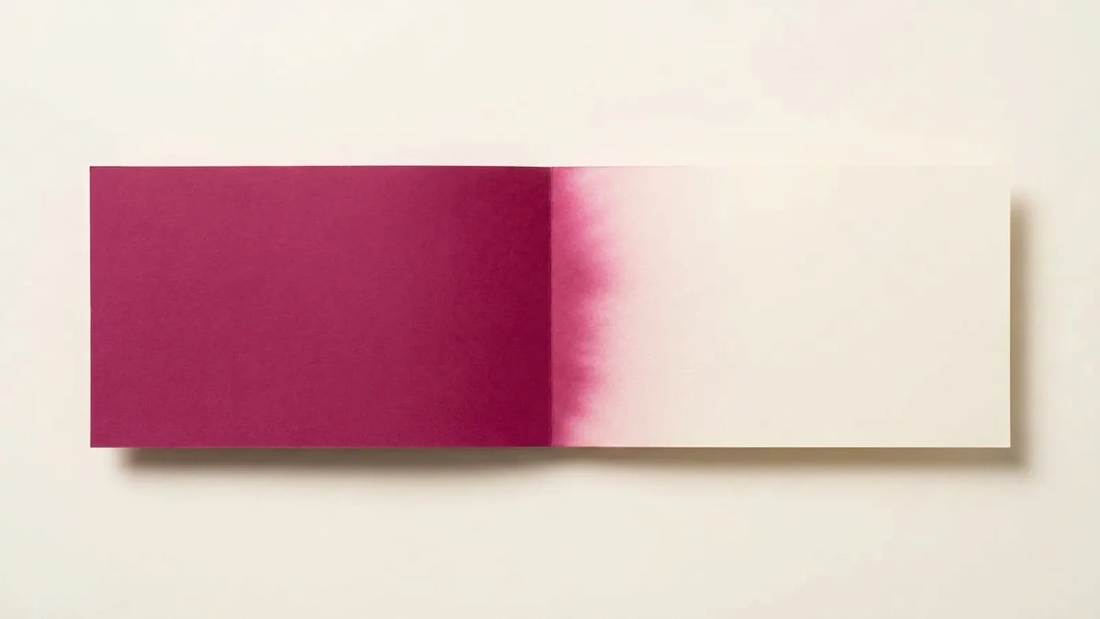 Paper-craft illustration of one coloured sheet touching another, its colour bleeding across the join into the neighbouring edge