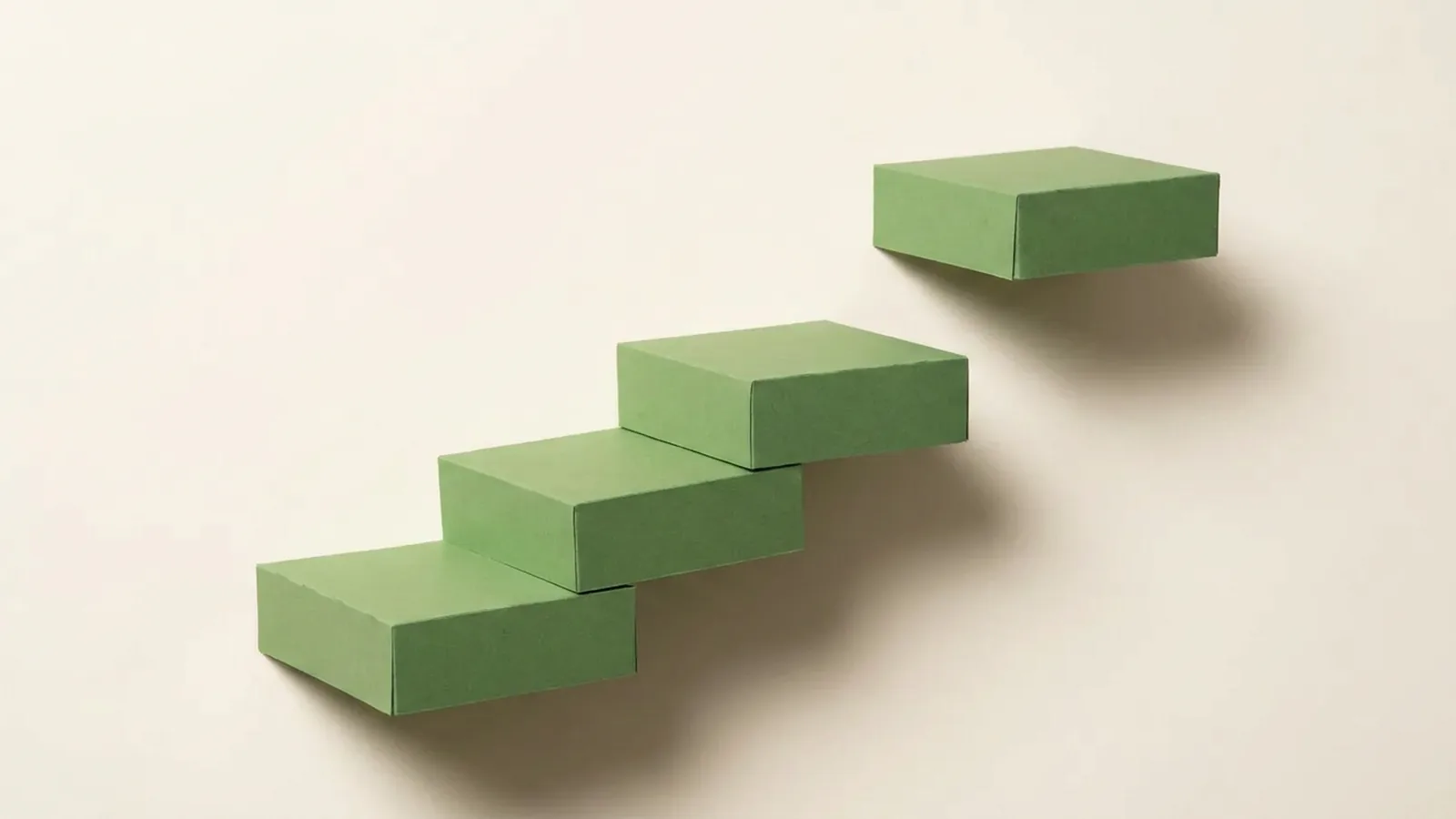 Paper-craft illustration of three rising steps with the topmost one detached, floating slightly out of reach